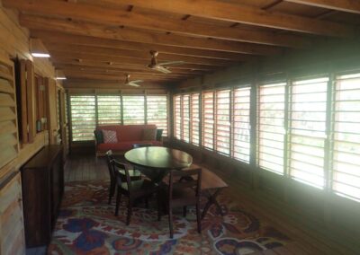 Dining with louvered indoor/outdoor space. Pass-through to kitchen.